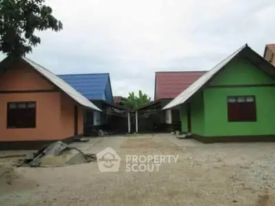 Charming colorful houses with unique roof designs in a serene neighborhood setting.