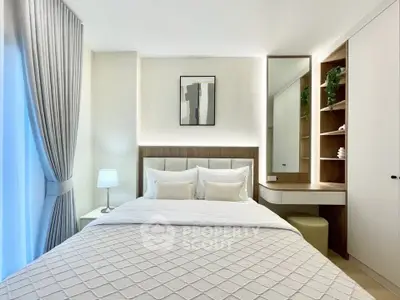 Modern bedroom with elegant decor, featuring a cozy bed, stylish lamp, and built-in shelving for a luxurious feel.