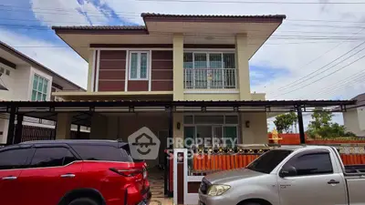 Modern two-story house with carport and stylish facade in suburban neighborhood.