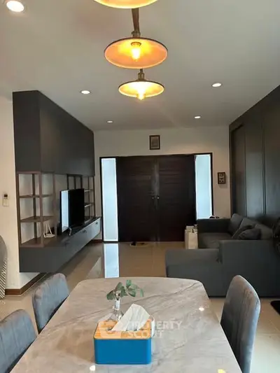 Modern living room with elegant decor and spacious layout, featuring a stylish dining area and cozy seating.