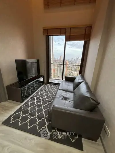 Modern living room with city view, featuring sleek leather sofa and large TV, perfect for urban living.
