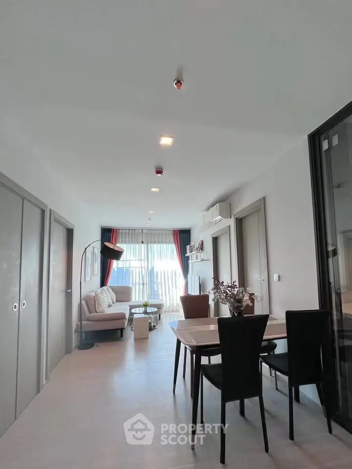 Modern living room with dining area and large windows in a stylish apartment
