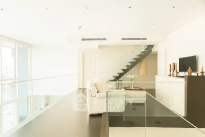 Luxurious modern living room with sleek staircase and panoramic windows