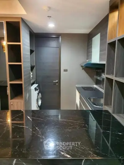 Modern kitchen with sleek black marble countertop and built-in appliances