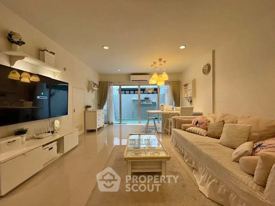 Spacious living room with modern decor and cozy seating area, perfect for relaxation and entertainment.