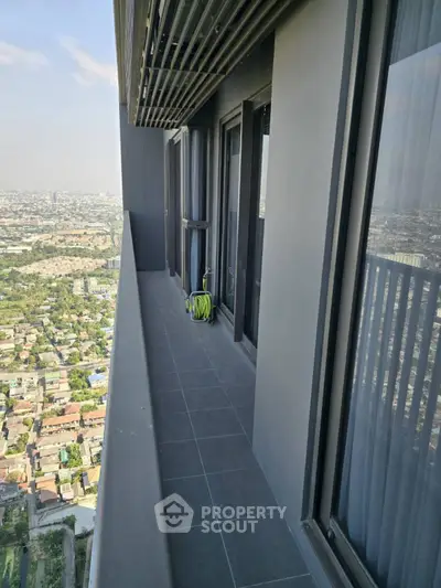 Stunning high-rise balcony with panoramic city views and sleek modern design.