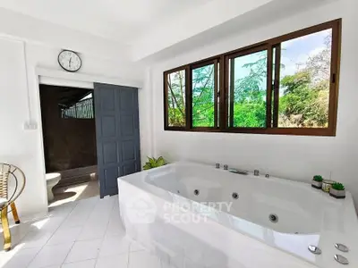 Luxurious bathroom with large bathtub and scenic window view