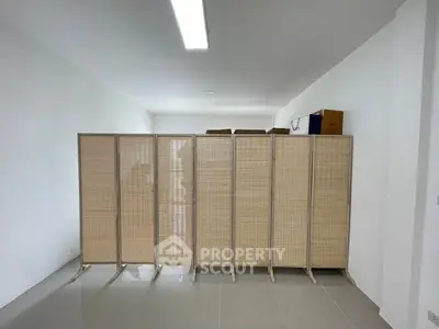 Spacious storage room with partition and tiled flooring