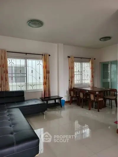 Spacious living room with modern furniture and large windows for natural light.