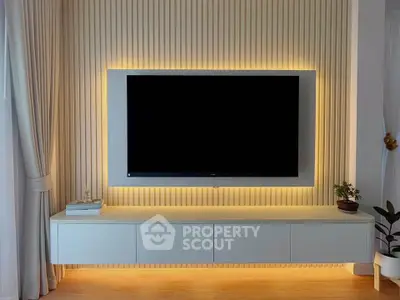 Modern living room with sleek TV setup and ambient lighting