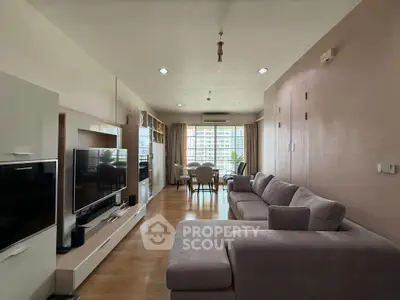 Spacious living room with modern decor and large windows offering natural light.