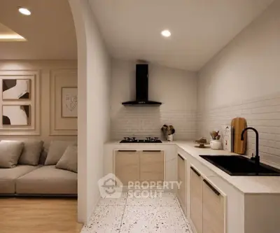 Modern kitchen with sleek design and open layout adjacent to cozy living area.