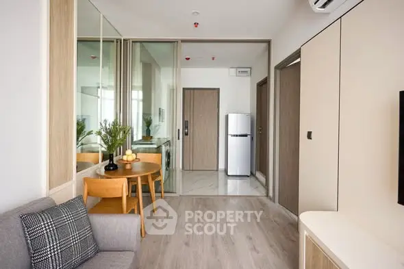 Modern living room with sleek design and compact kitchen area