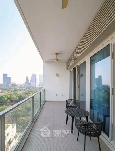 Spacious balcony with city view and modern outdoor seating.