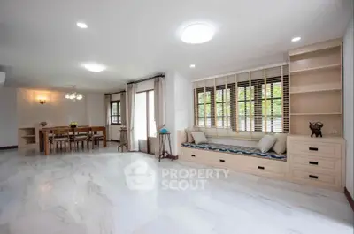 Spacious living room with elegant dining area and large windows for natural light.