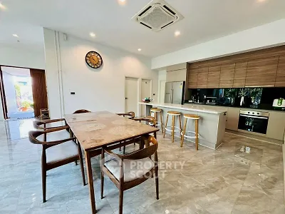 Spacious modern kitchen with dining area and sleek design in open layout