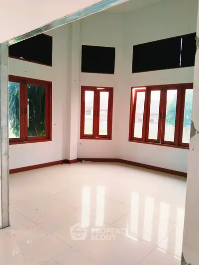 Spacious corner unit with large windows and natural light in modern home.