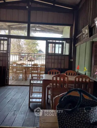 Charming rustic dining area with wooden furniture and open view, perfect for cozy gatherings.
