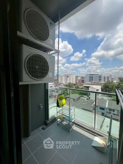 Modern balcony with city view and air conditioning units, perfect for urban living.