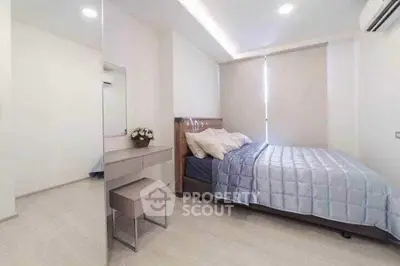Modern bedroom with sleek design, featuring a cozy bed and stylish decor in a bright, airy space.