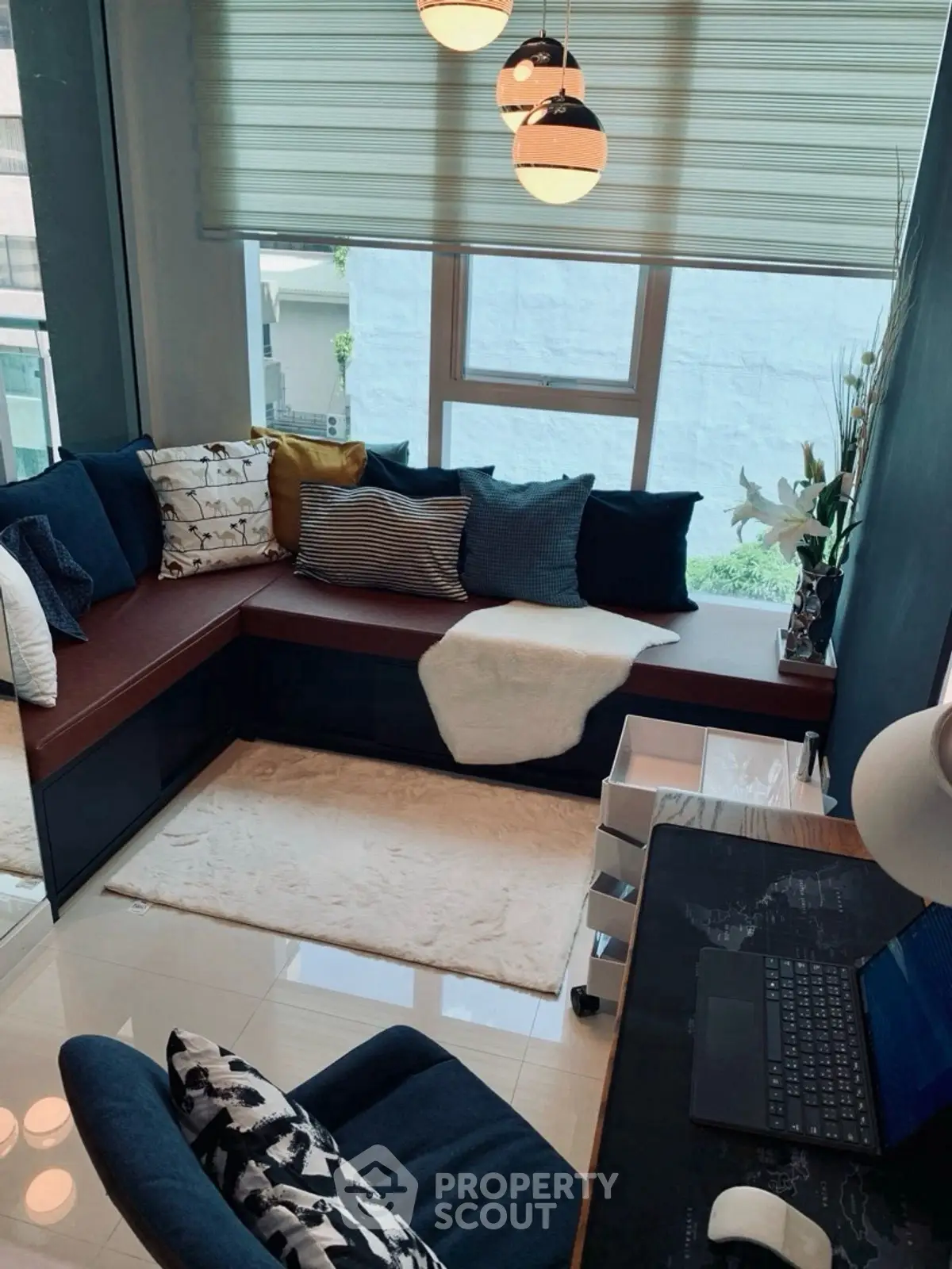 Chic modern living room with cozy seating and stylish decor, perfect for relaxation and work-from-home setup.