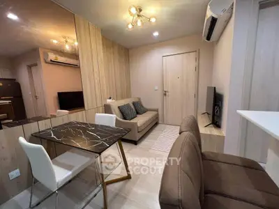 Modern living room with stylish furniture and elegant lighting in a cozy apartment.