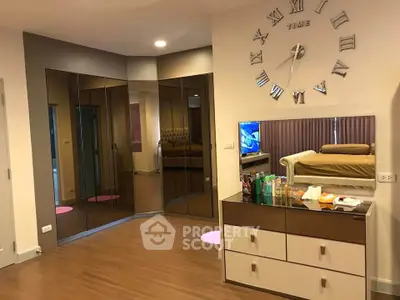 Spacious bedroom with mirrored closet and modern decor