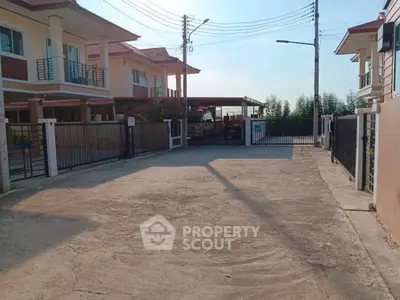 Spacious driveway entrance to modern residential property with gated access and ample parking space.