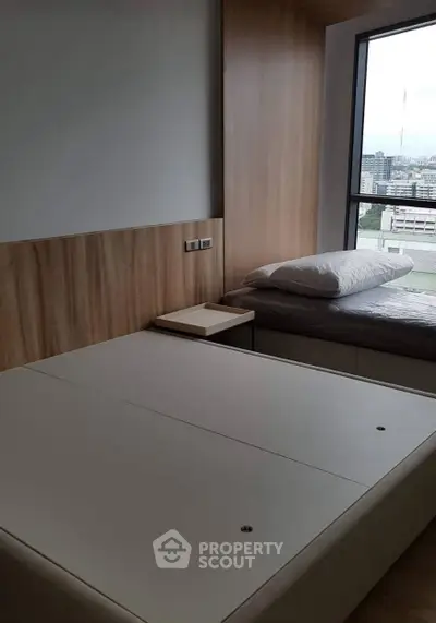 Modern bedroom with city view and sleek wooden paneling
