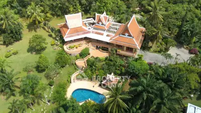 Stunning aerial view of luxury villa with pool and lush garden