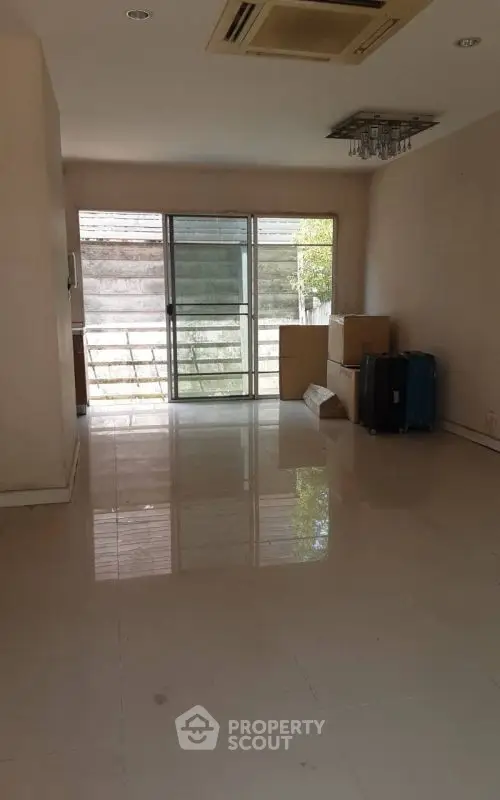 Spacious empty room with large windows and tiled flooring, ideal for customization.
