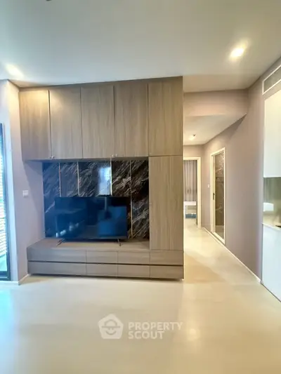 Modern living room with built-in TV cabinet and sleek design