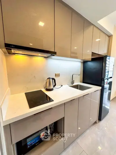 Modern kitchen with sleek cabinets and built-in appliances in a stylish apartment.