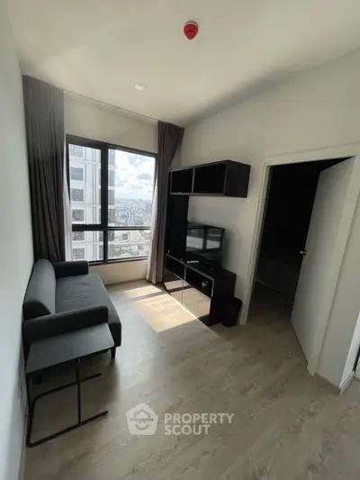 Modern living room with city view, sleek furniture, and natural light.