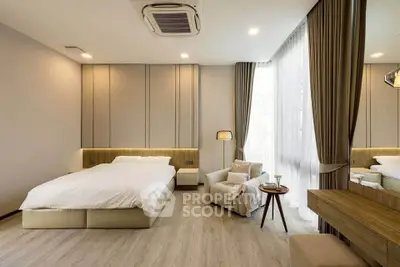 Luxurious bedroom with modern decor, large windows, and elegant furnishings for a serene living experience.