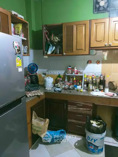 Cozy kitchen with wooden cabinets and modern appliances, perfect for culinary enthusiasts.