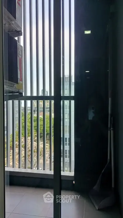 Modern apartment balcony with city view and sleek railing design.