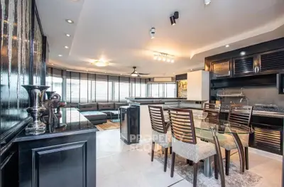 Luxurious open-plan living and dining area with modern decor and ample natural light.