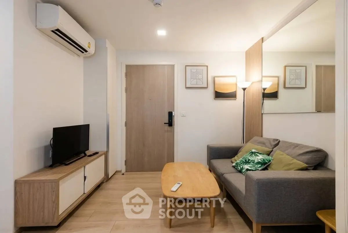 Modern living room with cozy sofa, TV, and stylish decor in a contemporary apartment.