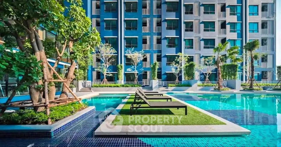 Luxurious modern apartment complex with stunning pool and lush greenery, perfect for urban living.