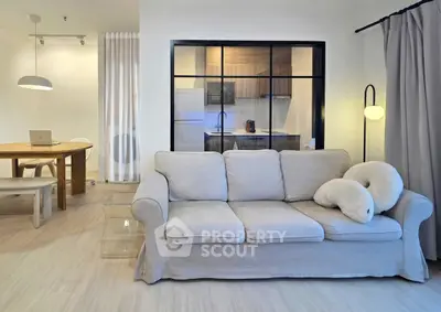 Modern living room with cozy sofa and open kitchen layout