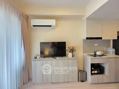 Modern living room with air conditioning and sleek kitchen area