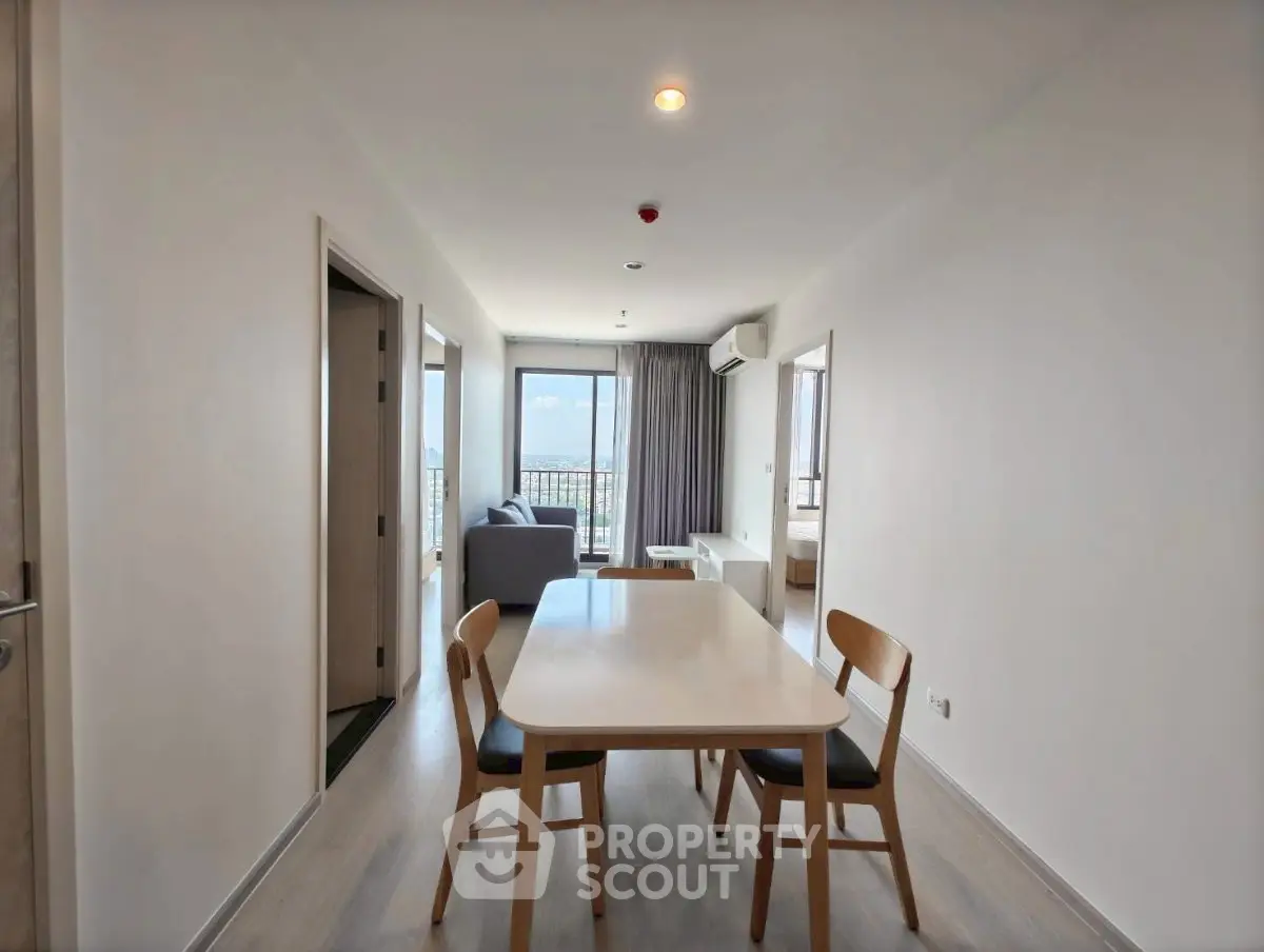Modern apartment interior with dining area and balcony view