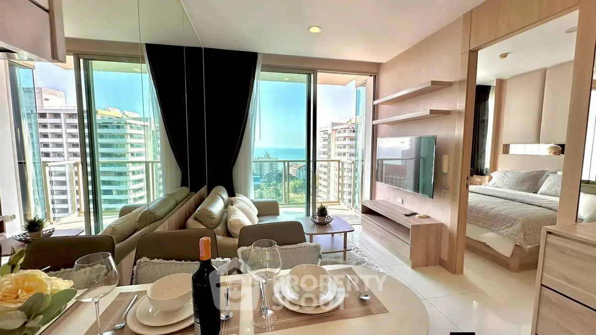 Luxurious modern living room with stunning ocean view and elegant dining setup.