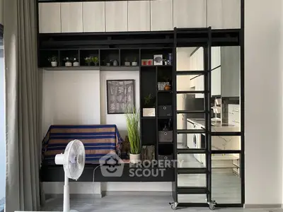 Modern studio apartment with loft bed, sleek storage, and open kitchen layout.