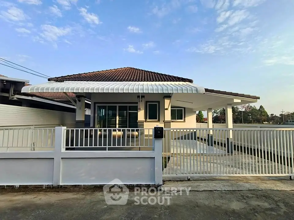 Charming single-story home with a spacious driveway and modern design, perfect for family living.