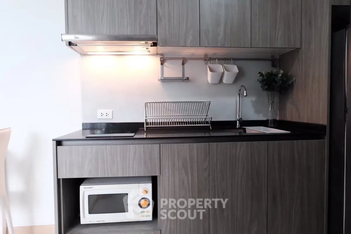 Modern kitchen with sleek cabinetry and built-in microwave
