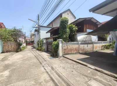 Charming residential street view with traditional houses and lush greenery.