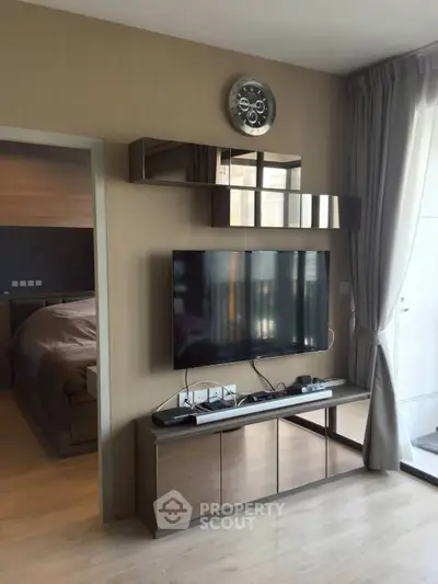 Modern living room with wall-mounted TV and sleek furniture design