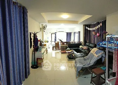 Spacious living room with modern decor and ample natural light, perfect for family gatherings.